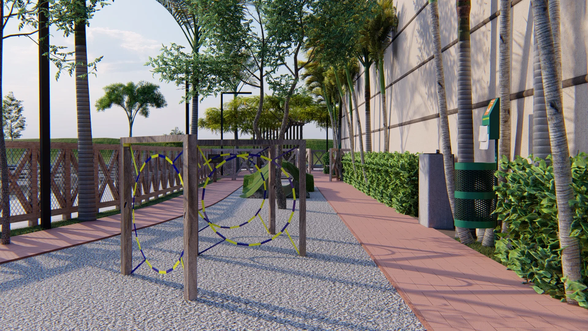 Trecho do circuito de agility com obstáculos de cordas azuis e amarelas, rampa verde e estação de resíduos junto à sebe do mall