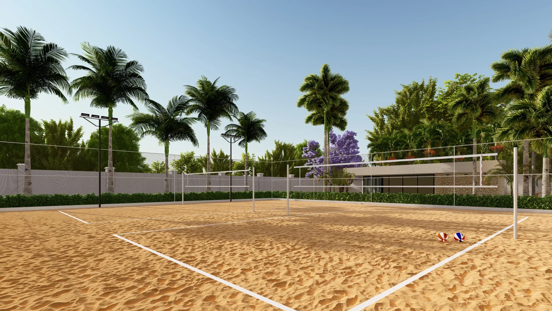 Quadra de vôlei de areia com redes e postes de iluminação, cercada por palmeiras e uma árvore de flores lilás ao fundo