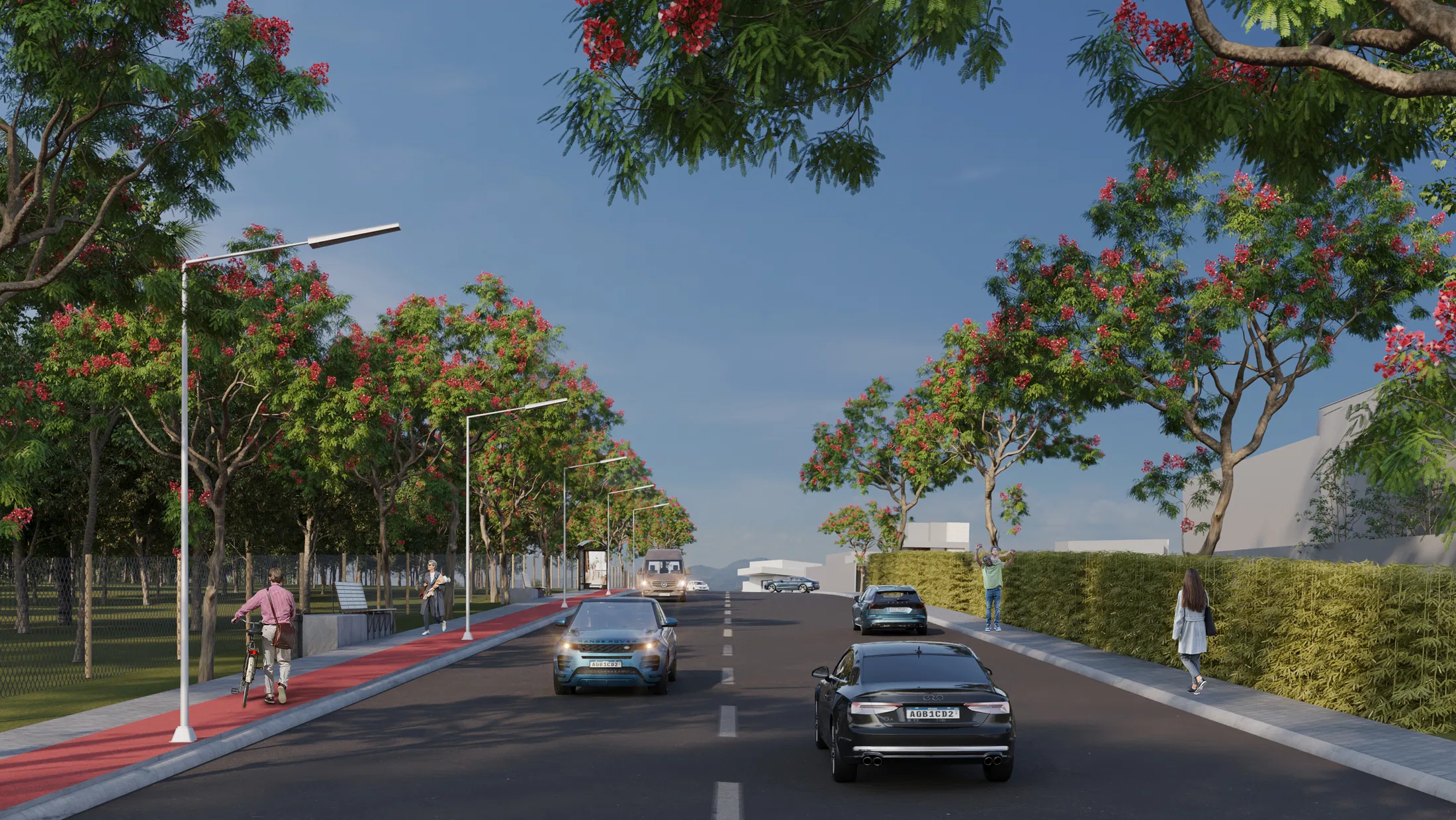 Alameda emoldurada por flamboyants de copa vermelha florida, com carros na pista, ciclista na ciclovia e pedestres na calçada