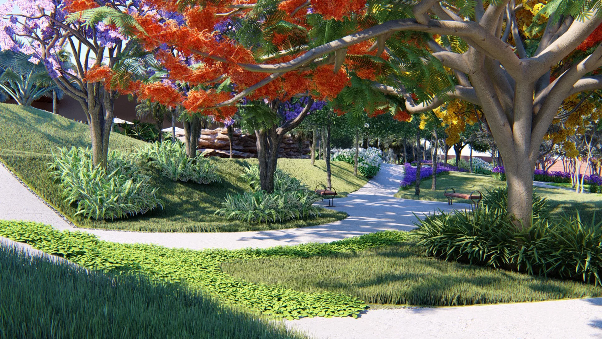 Alameda diurna sob árvore de floração alaranjada, com florações roxas e amarelas ao fundo, caminho curvo com bancos e canteiros geométricos de gramíneas