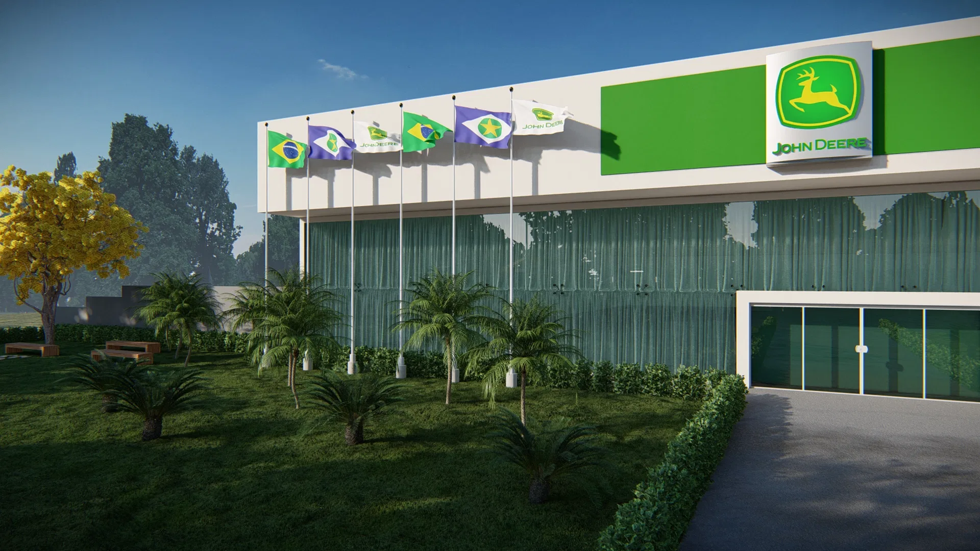 Fachada envidraçada de concessionária com testeira verde, fileira de bandeiras, palmeiras jovens e árvore de flores amarelas no gramado