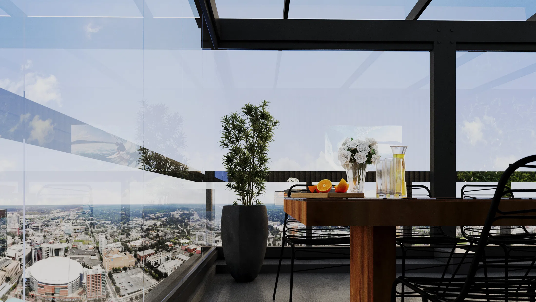 Canto do terraço junto ao guarda-corpo de vidro, com mesa de madeira, roseiras brancas, árvore em vaso e panorama urbano.