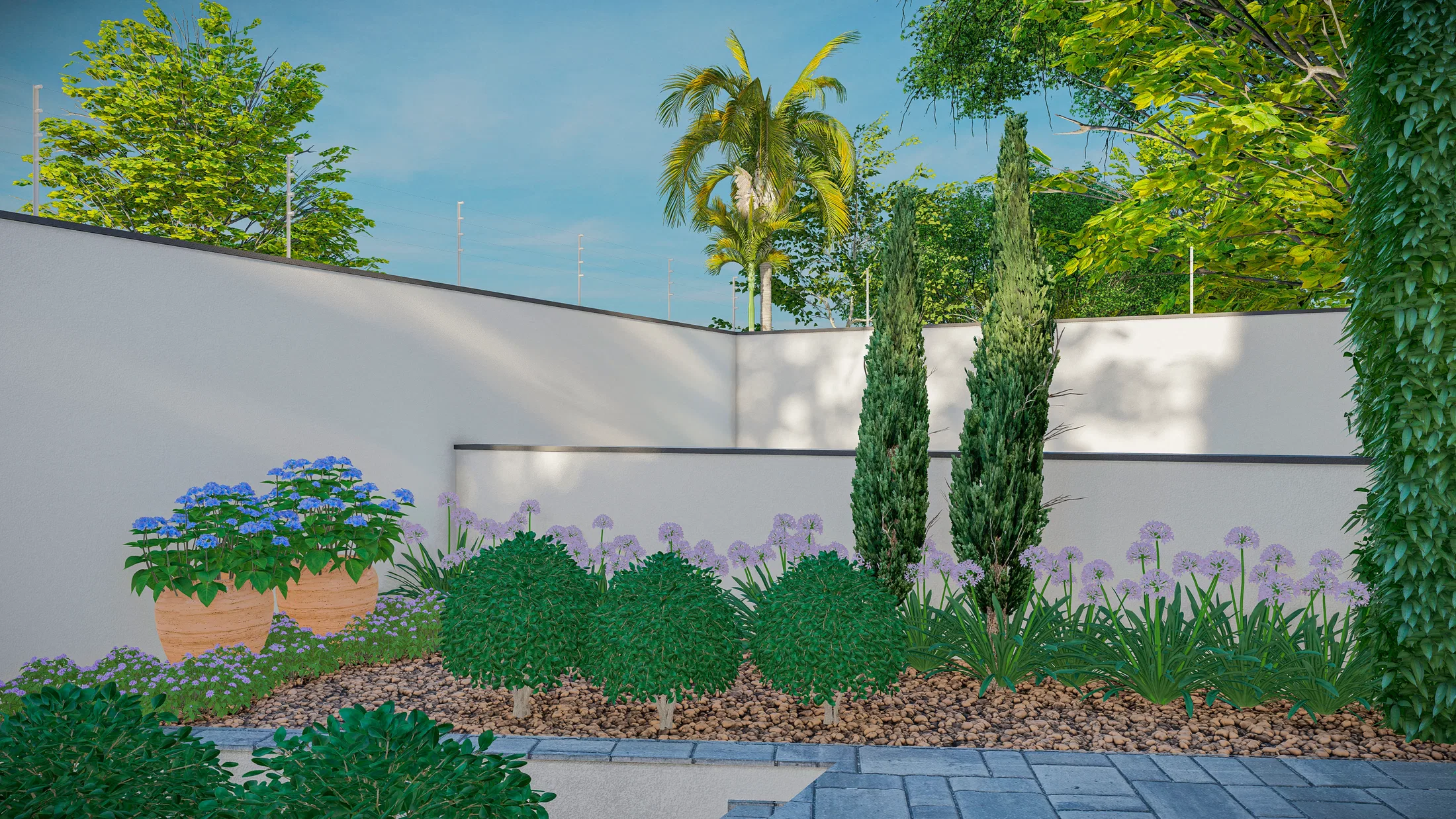 Canteiro de hortênsias azuis e agapantos junto ao muro, com topiarias em espiral e palmeira ao fundo