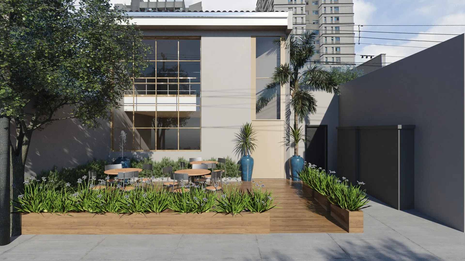 Fachada de restaurante com pátio externo arborizado, mesas e cadeiras ao ar livre, canteiro com agapantos floridos e prédios ao fundo