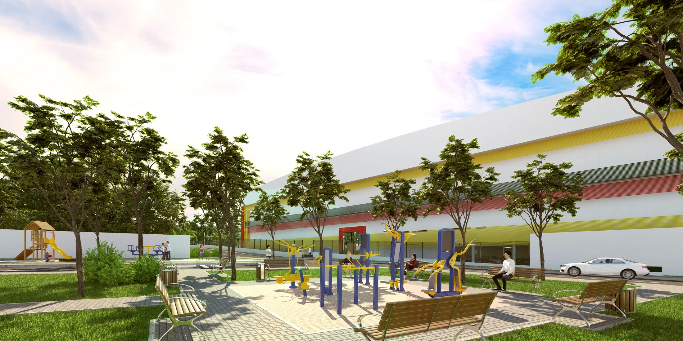 Praça de lazer externa com equipamentos de ginástica azuis e amarelos, playground, bancos e árvores de sombra diante da fachada listrada do shopping