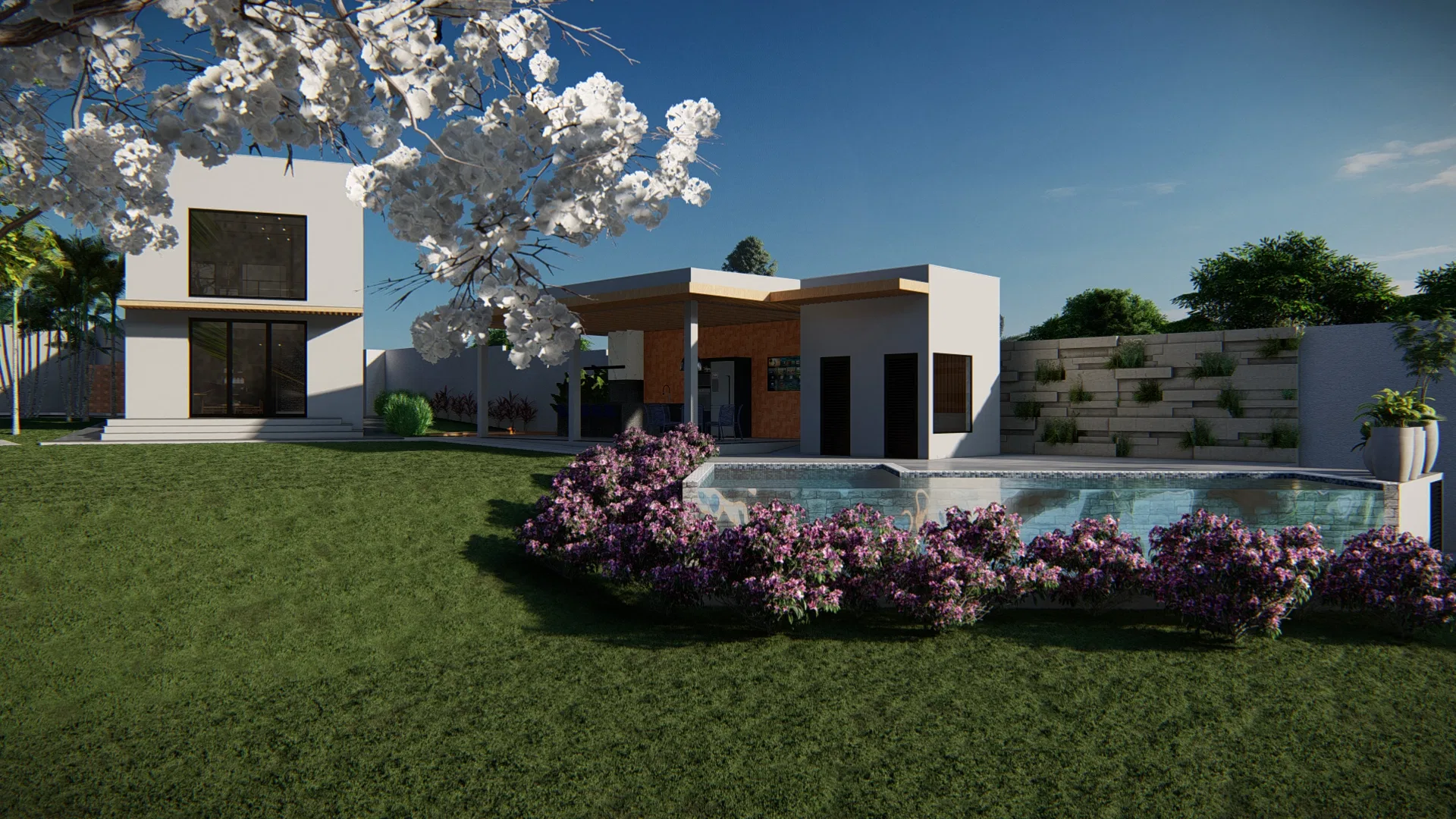Jardim com árvore florida branca e canteiro de flores roxas emoldurando a piscina de borda estreita junto ao muro