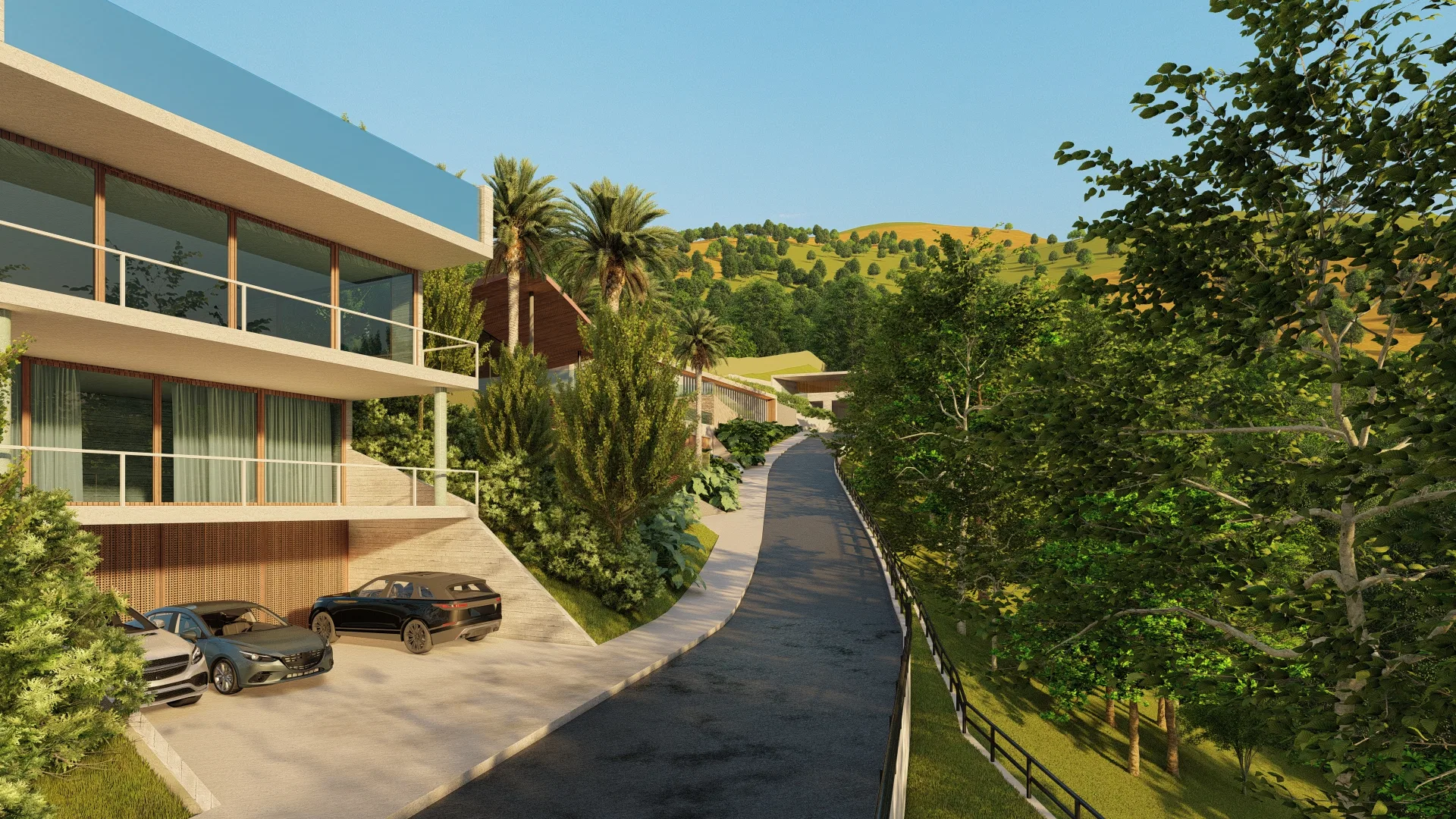 Fachada lateral de residência com varandas de vidro ao longo de via interna arborizada que sobe a encosta