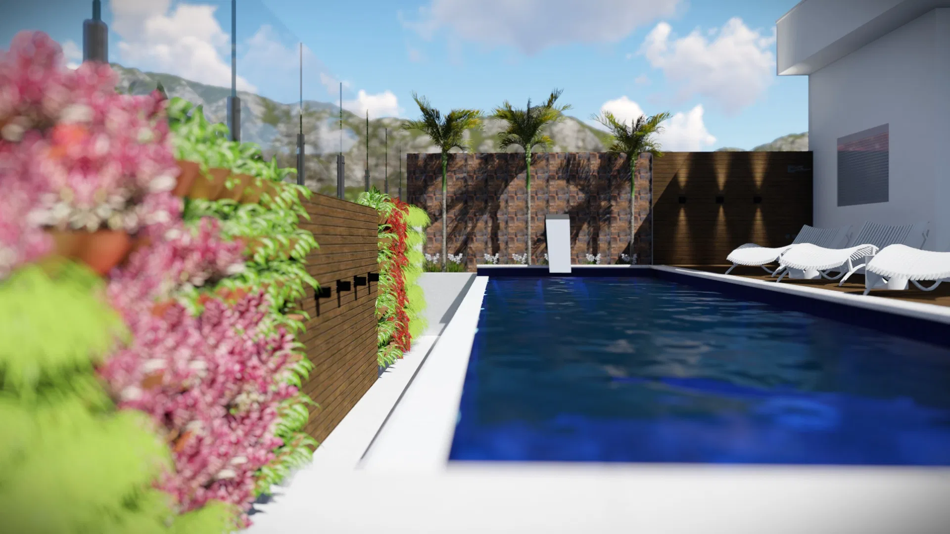 Piscina de raia margeada por jardim vertical florido em buganvília e ripado de madeira, com palmeiras, espreguiçadeiras e serra ao fundo