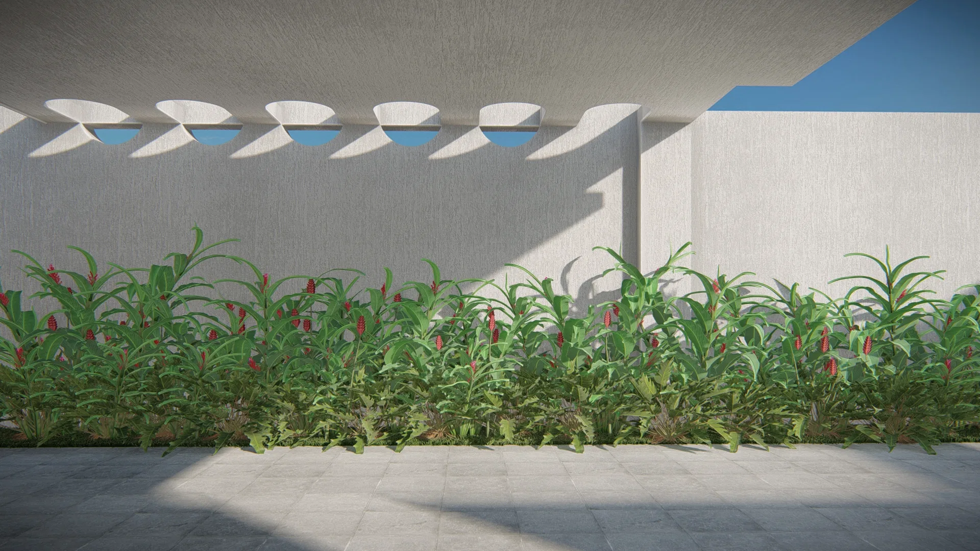 Brise de concreto com aberturas curvas projetando sombras sobre o muro, e faixa de folhagens tropicais com flores vermelhas rente ao piso