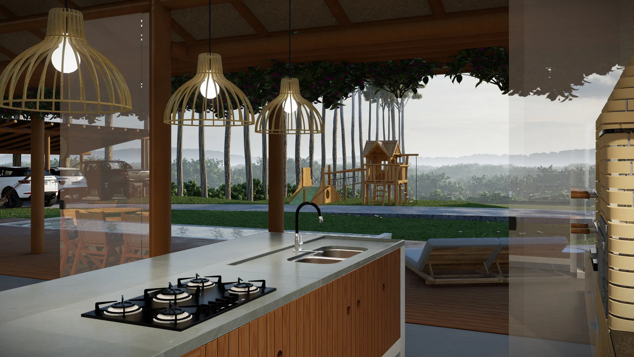Ilha de cozinha com cooktop e pia, vista através do vidro para playground de madeira e piscina ao fundo