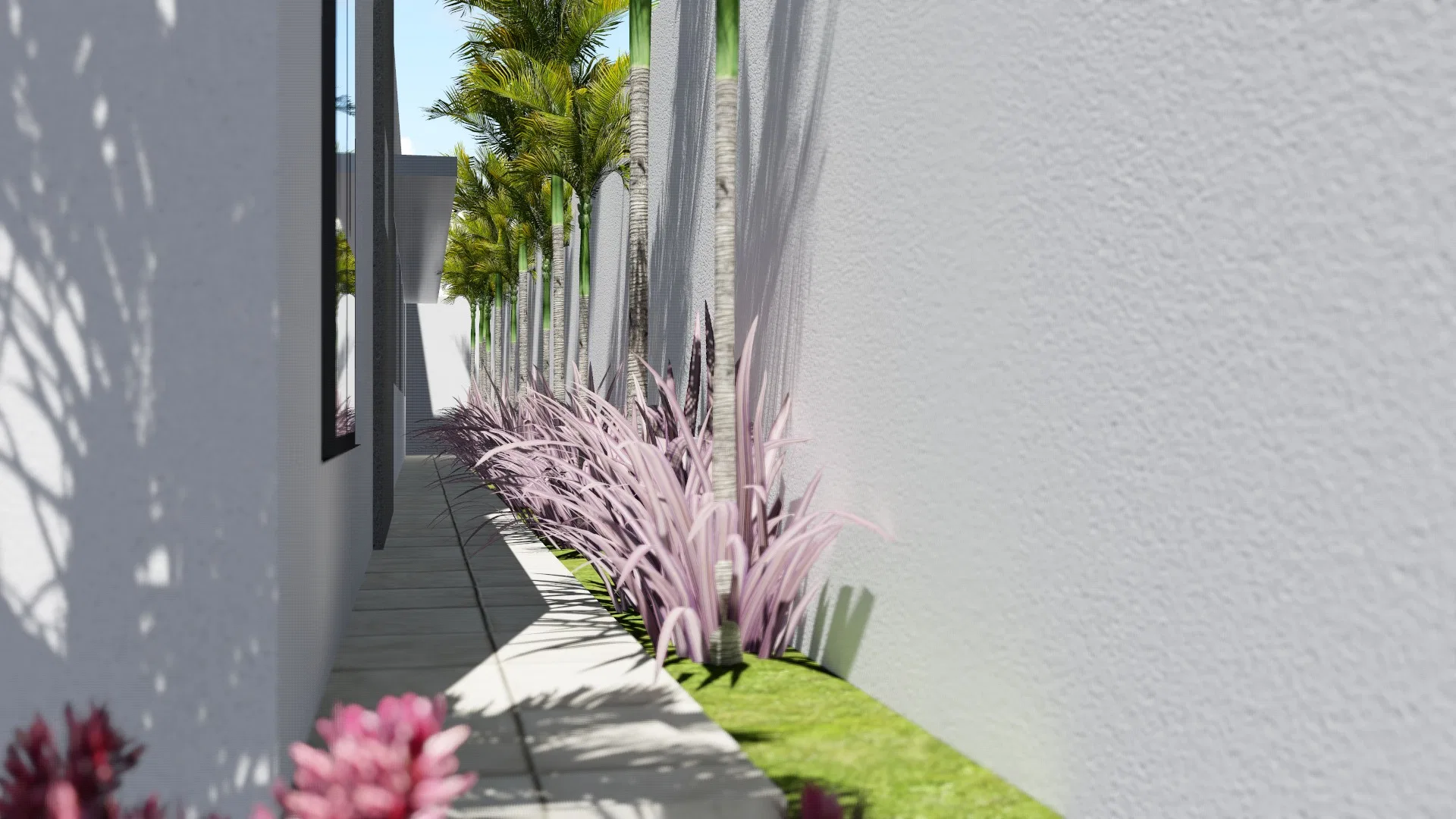 Corredor lateral com capim ornamental rosado ao longo do canteiro, palmeiras ao fundo e flores rosa em primeiro plano
