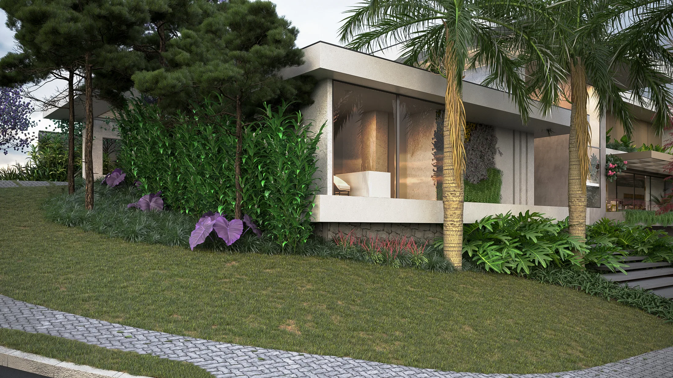 Lateral da casa com sala envidraçada voltada ao jardim, talude gramado, pinheiros, folhagens roxas e caminho curvo de pedra portuguesa
