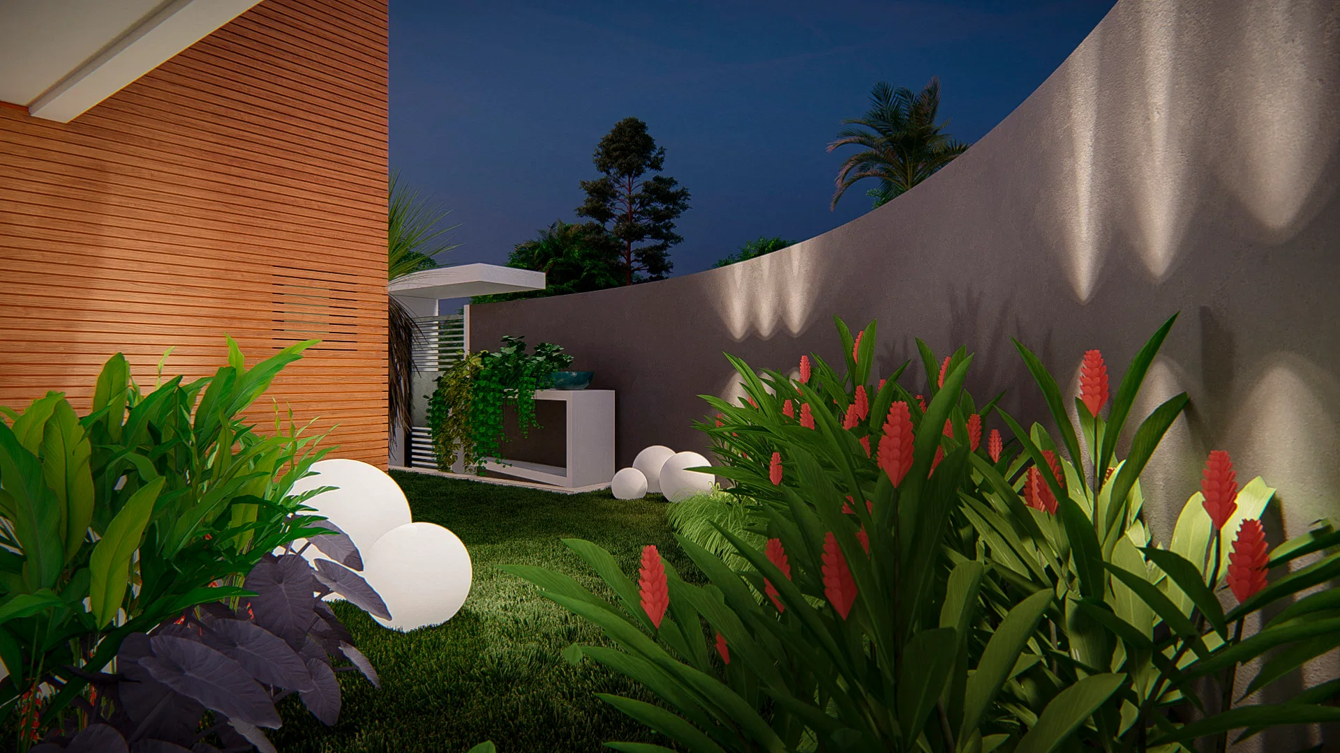 Recanto do jardim com flores vermelhas e folhagem arroxeada em primeiro plano, muro curvo iluminado e aparador com planta pendente