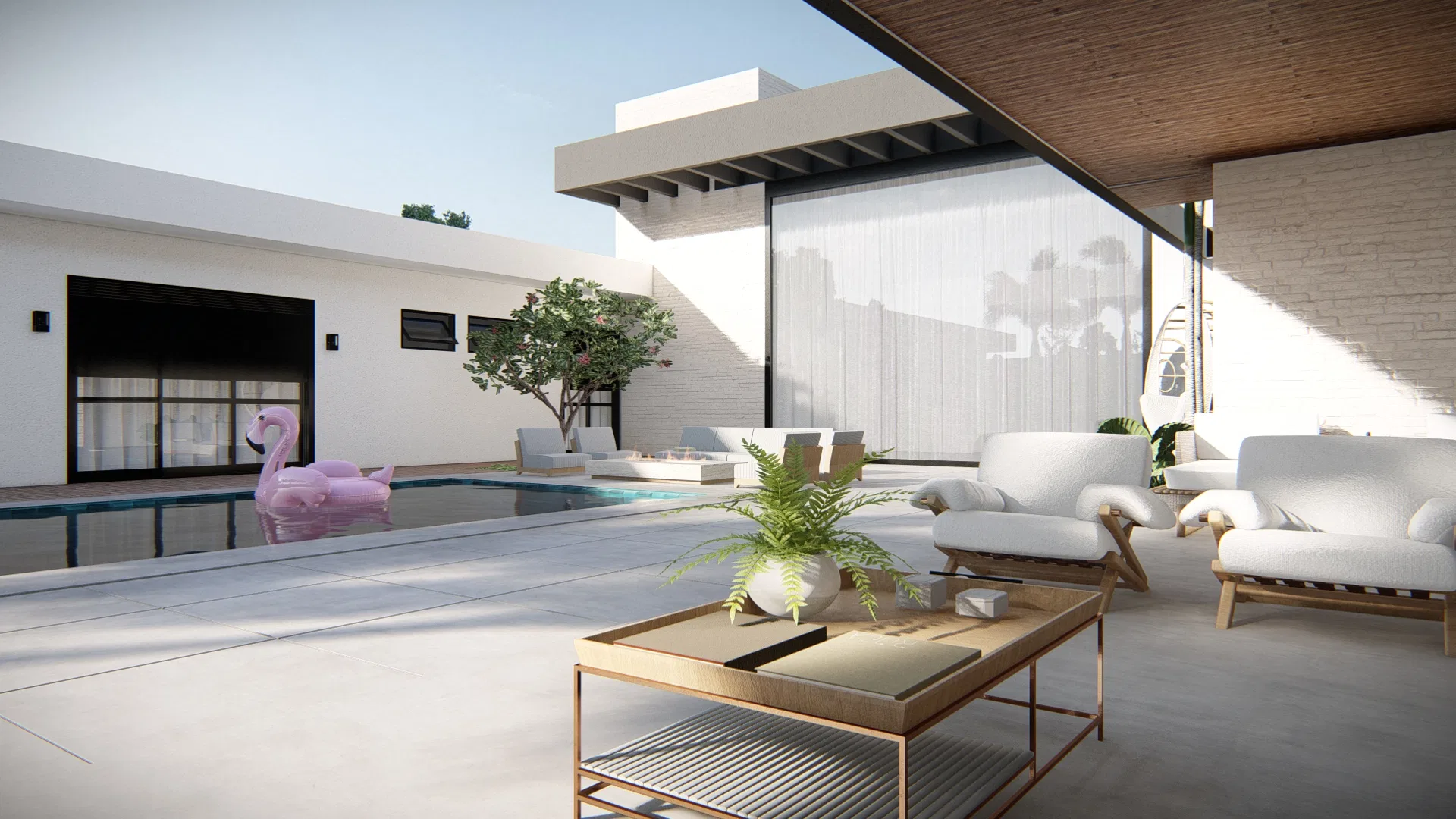 Estar externo coberto com poltronas brancas e mesa dourada, diante da piscina com boia de flamingo rosa e cortinas leves.